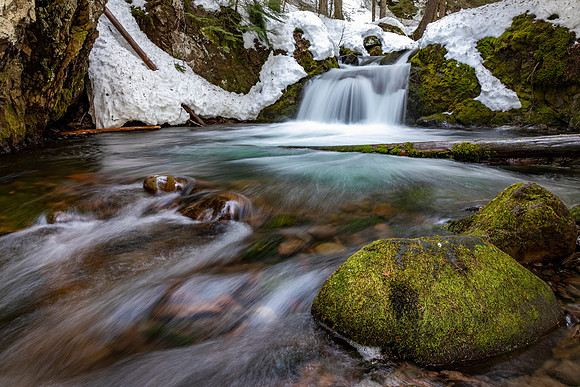 Small Waterfall Mt Hood Wilderness with moss and snow.